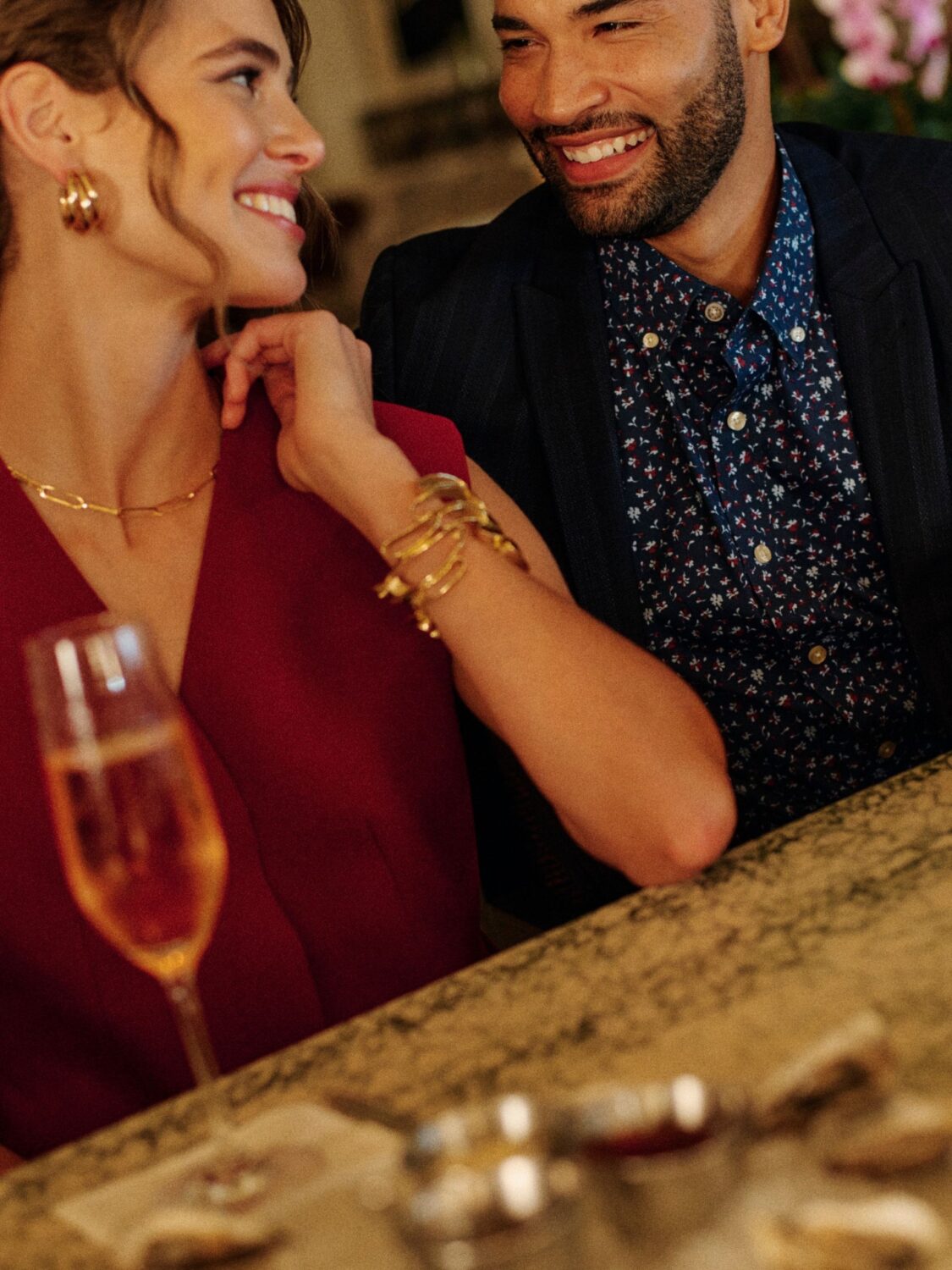 A couple sitting at the bar looking into each others eyes