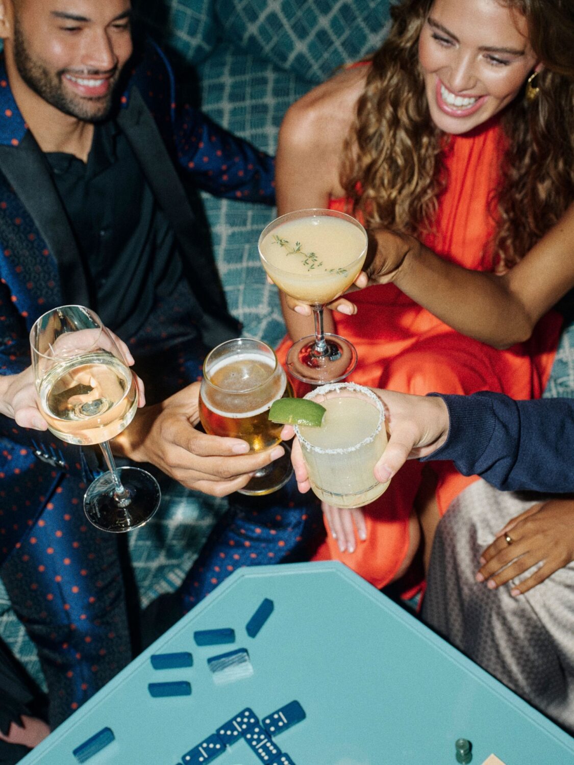 A group of friends enjoying cocktails and a cheers