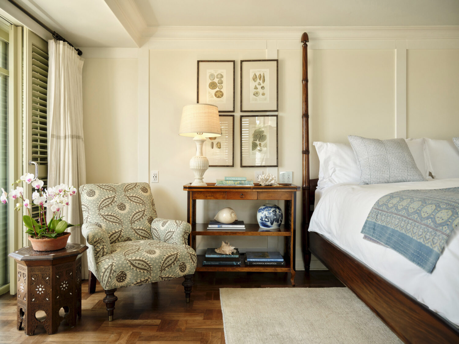 Cozy bedroom with a comfortable chair, table, and soft lighting.