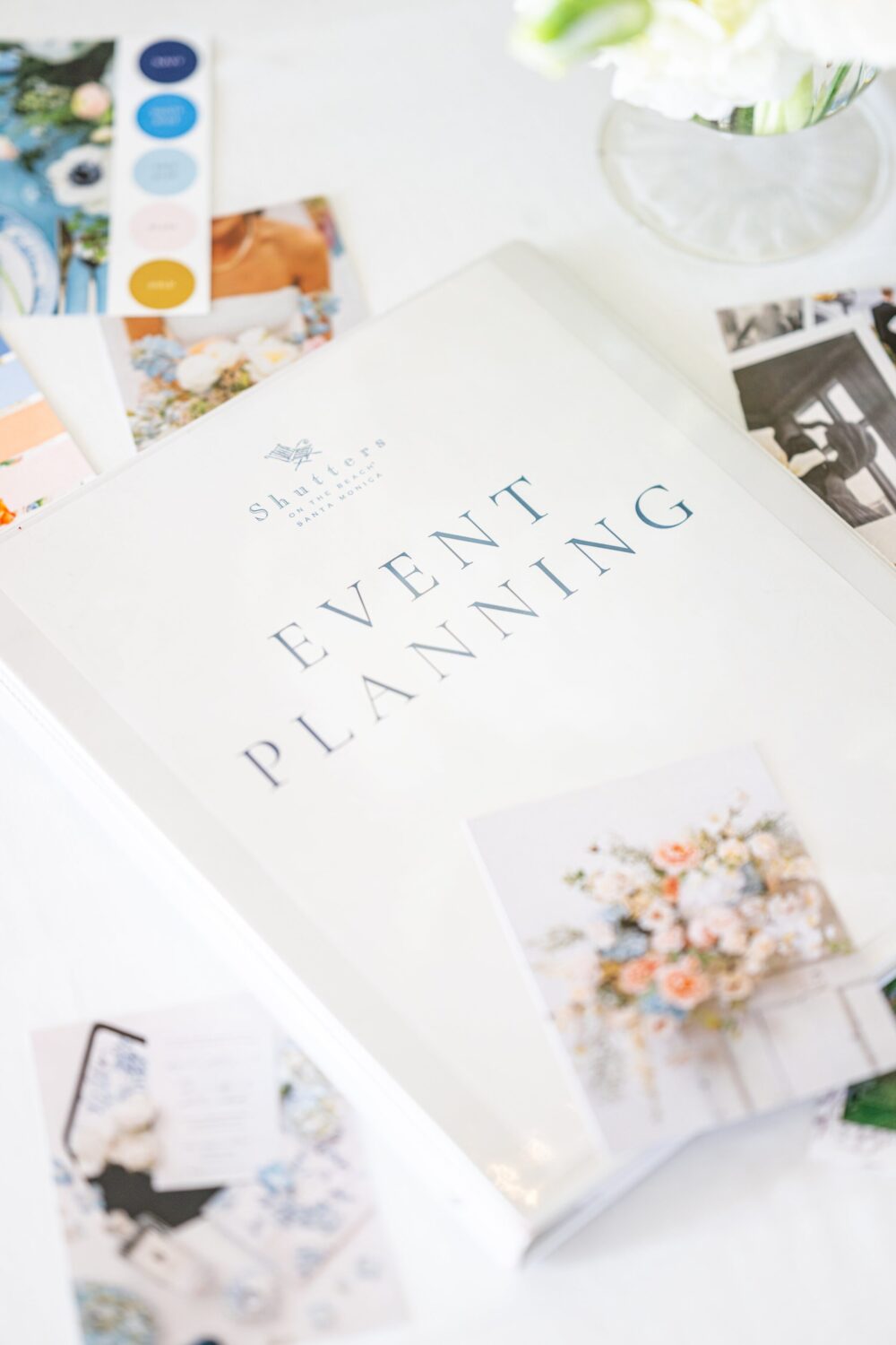 Event planning binder with floral photos, color palettes, and design ideas.