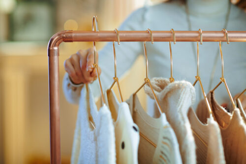 gold hangers with clothes on them in the cottage boutique