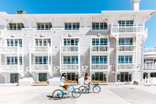 Shutters hotel in the background with 2 girls biking