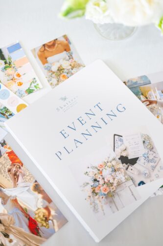 Shutters event planning binder with floral arrangements and decorative images on the cover.