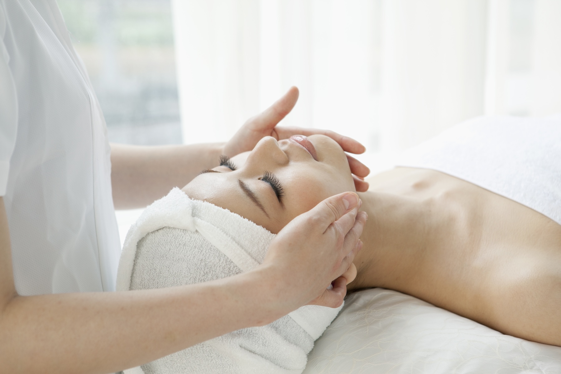 Woman receiving a facial treatment.