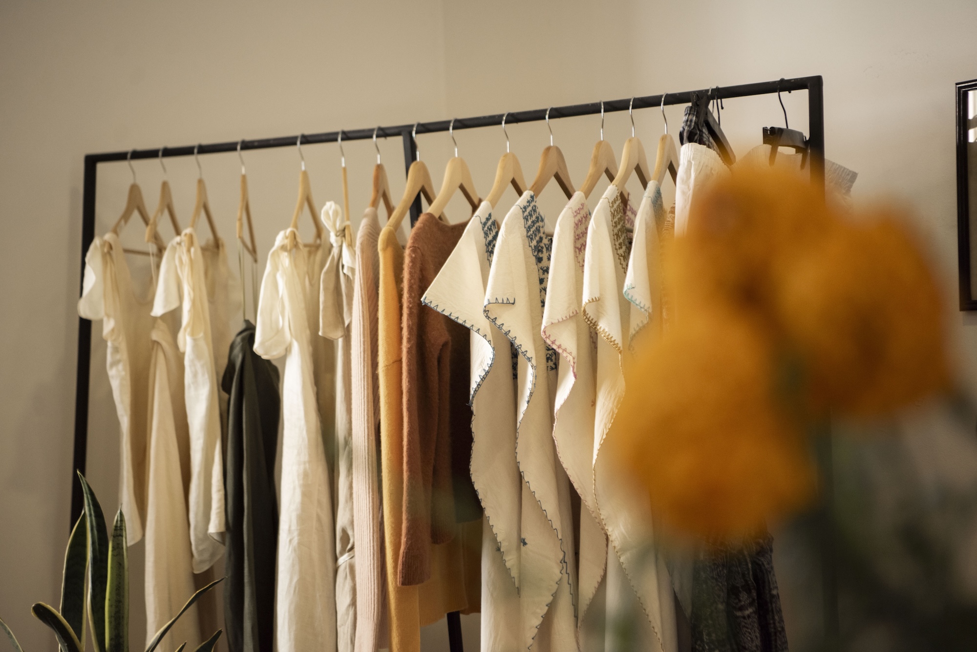 A clothing rack filled with white shirts.
