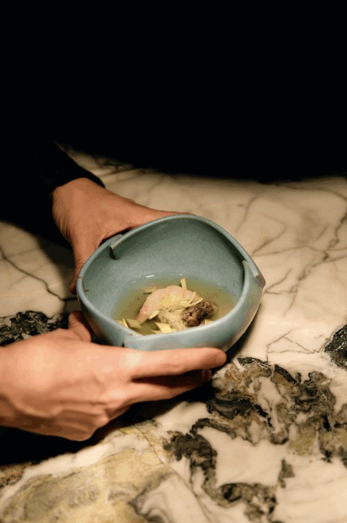 A person holding a bowl of food.