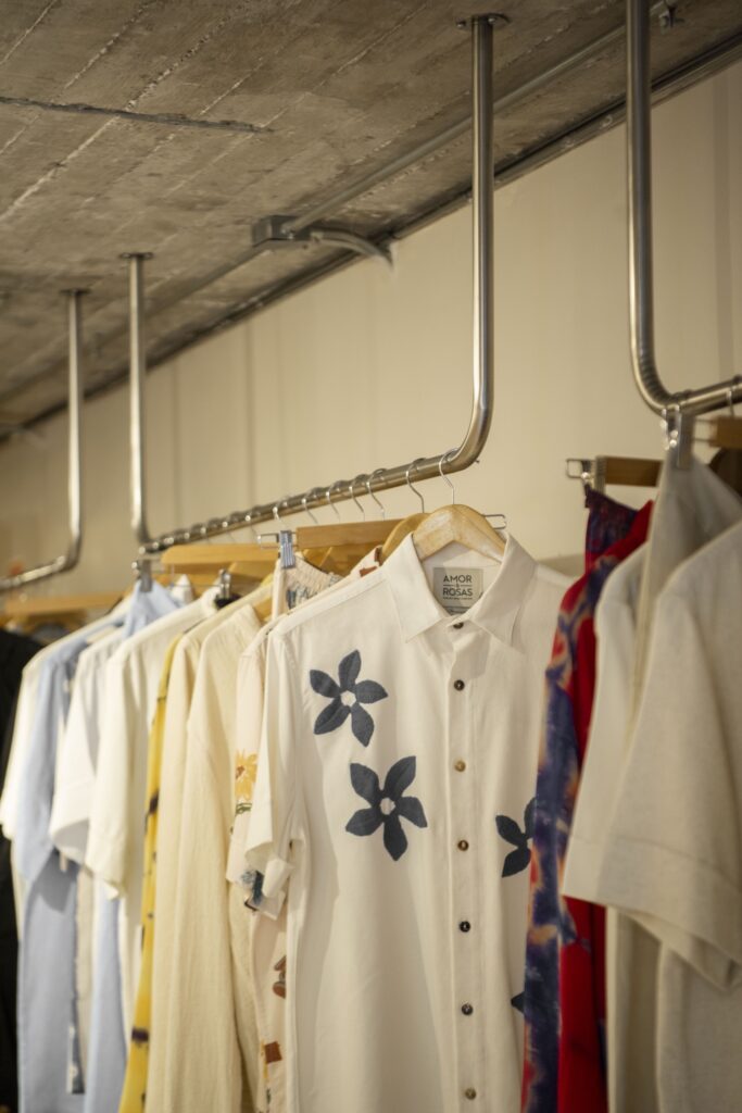 Clothes on a clothing rack at Amor & Rosas.