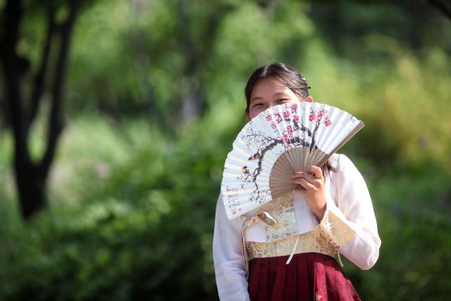 Teen in traditional dress during a summer teen tour of South Korea