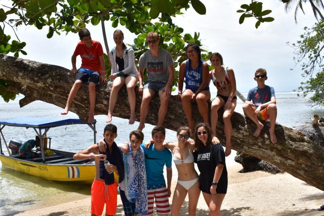 Younger teens climb a tree on their student tour of Costa Rica.