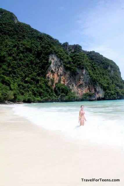 Teenage traveler swims in Pacific Ocean during summer youth program in Southeast Asia