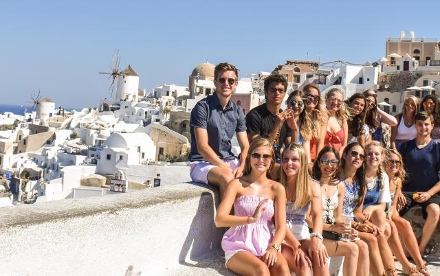 High school students smile in Santorini on their summer teen tour to Greece.