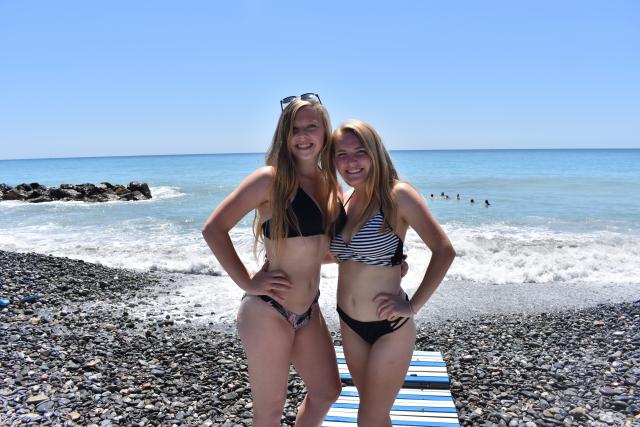 Teenage travelers on French Riviera beach in Nice during summer youth travel program
