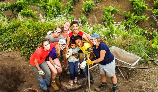 High school students pose with their local family in Sicily on their service program to Italy.