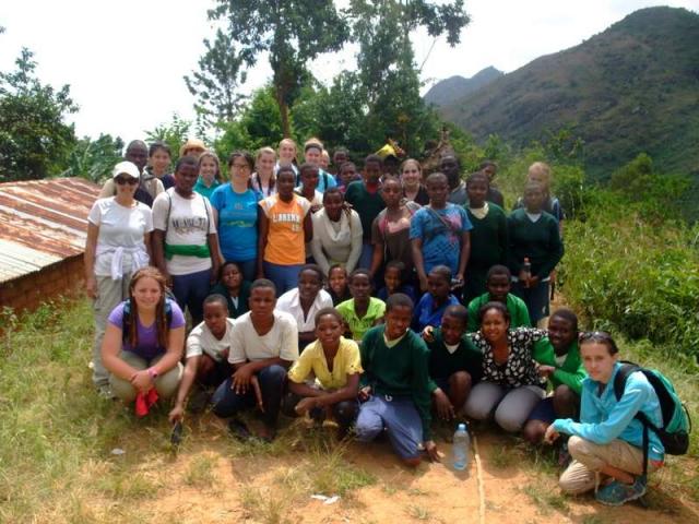Teens finish a hike with community hosts during summer service program in Tanzania.