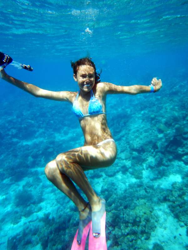 Teen traveler snorkels in the Great Barrier Reef on their high school summer program to Australia.