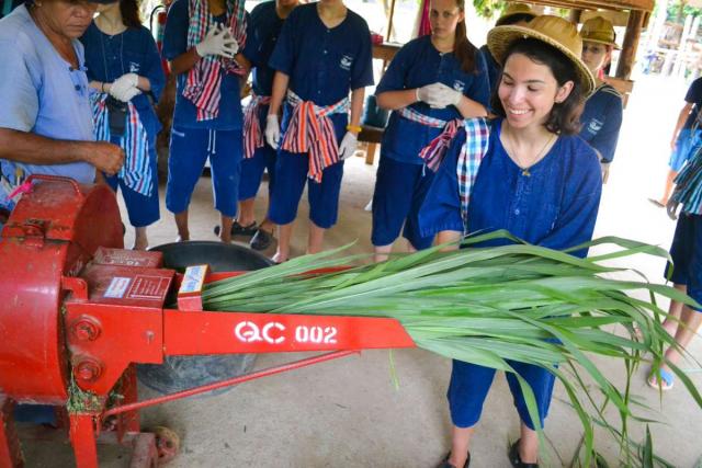 Teenage travelers make sugarcane juice during summer youth travel program in Thailand