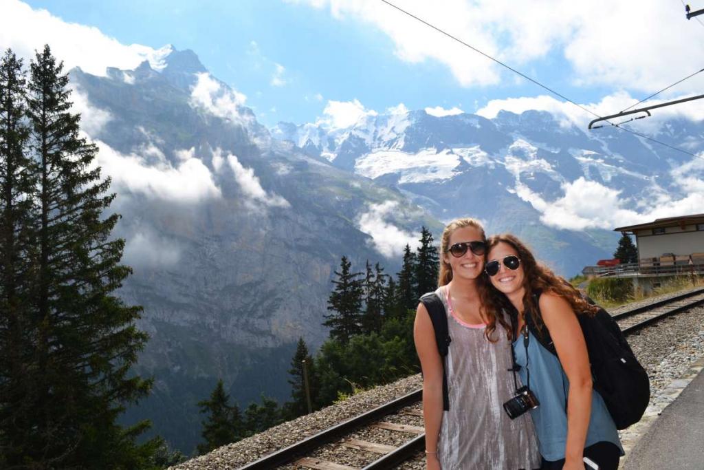 Teens smiling in Switzerland with the Alps in the background