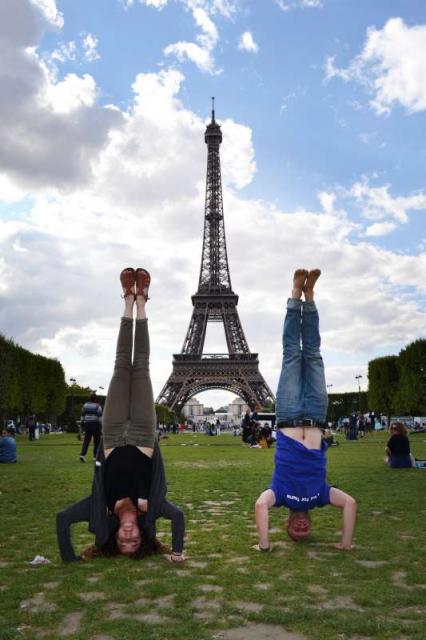 Teens having fun at Eiffel Tower in Paris during summer youth travel program