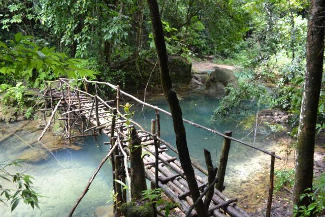 Wooden bridge over river seen by teenage travelers during summer youth program in Southeast Asia