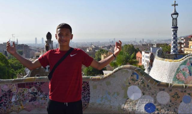 Teenage boy traveler in Parc Guell Barcelona on summer youth tour