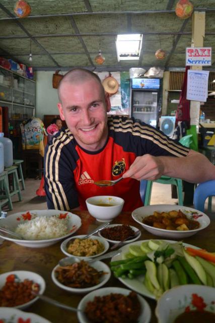 Teenage traveler eats local Thai cuisine during summer youth program in Southeast Asia