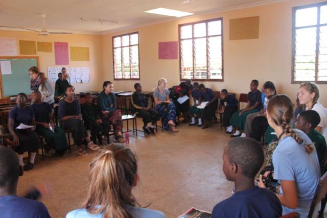 Teens play group games during summer service program in Tanzania.