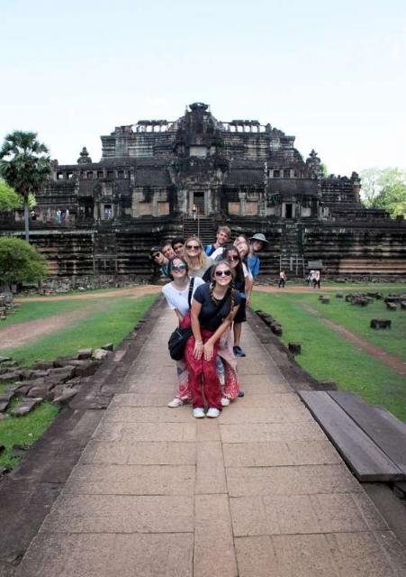 Teenage travelers visit temples during summer youth travel program in Thailand
