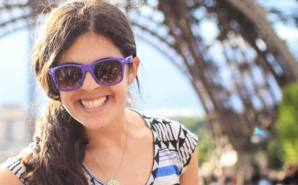 Teen smiling in front of the Eiffel Tower