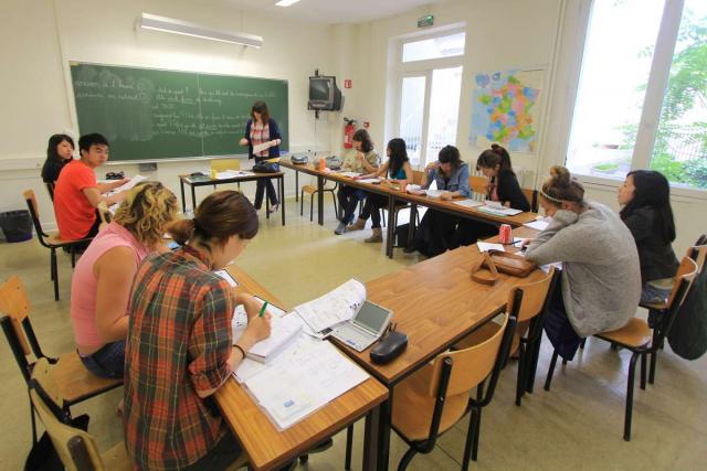Teenage travelers learning French at Paris academy during summer language immersion program