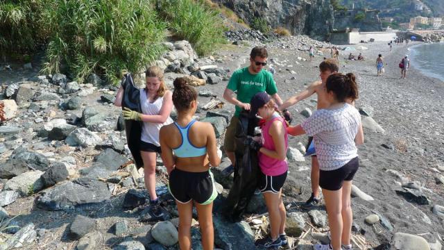 High school students do a beach clean up for service in the Cinque Terre on their summer teen tour to Italy.