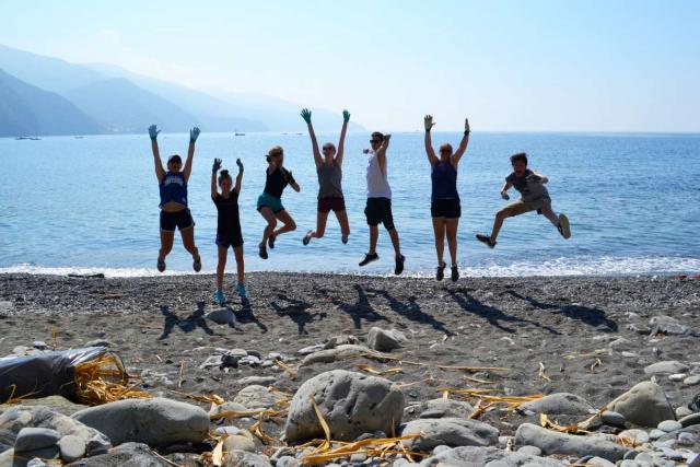 High school students relax on the beach after service work in the Cinque Terre on their summer teen tour to Italy.