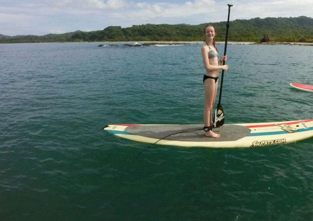 Teen learns how to stand-up on adventure program in Costa Rica.