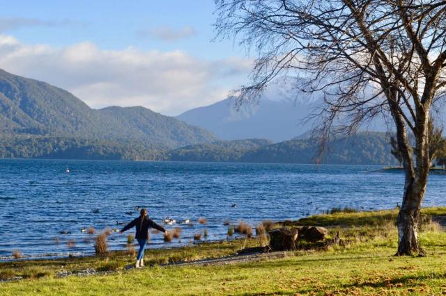 Happy teen traveler explores nature during summer youth travel program in New Zealand