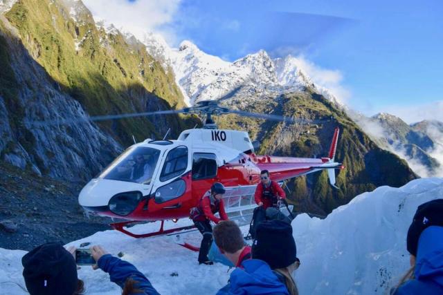 Teenage travelers go on helicopter tour during summer youth travel program in New Zealand