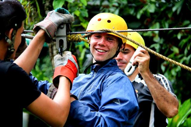 Teen gets ready to zip-line on his summer Spanish immersion teen tour in Costa Rica.