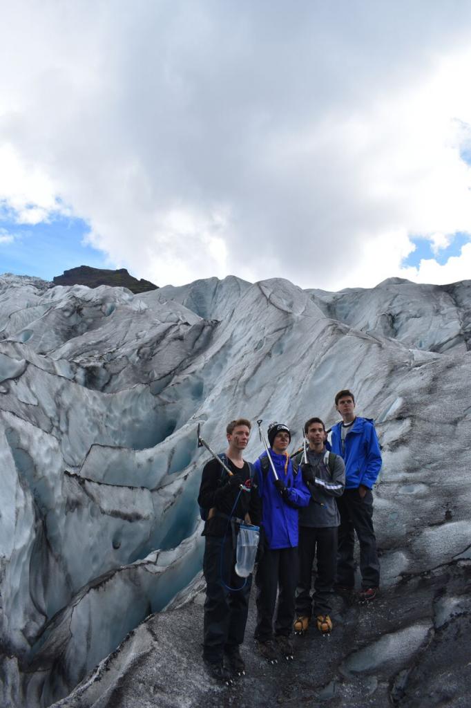 Teenage travelers do glacier hike during summer youth travel program in Scandinavia