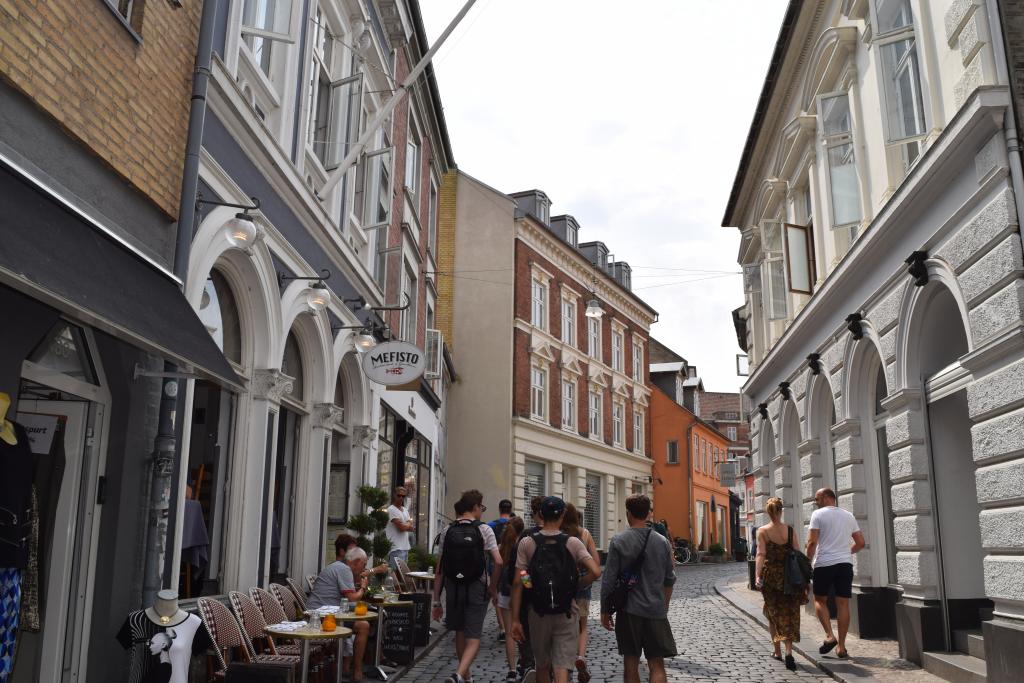 Teenage travelers explore small cobblestone streets during summer youth travel program in Scandinavia