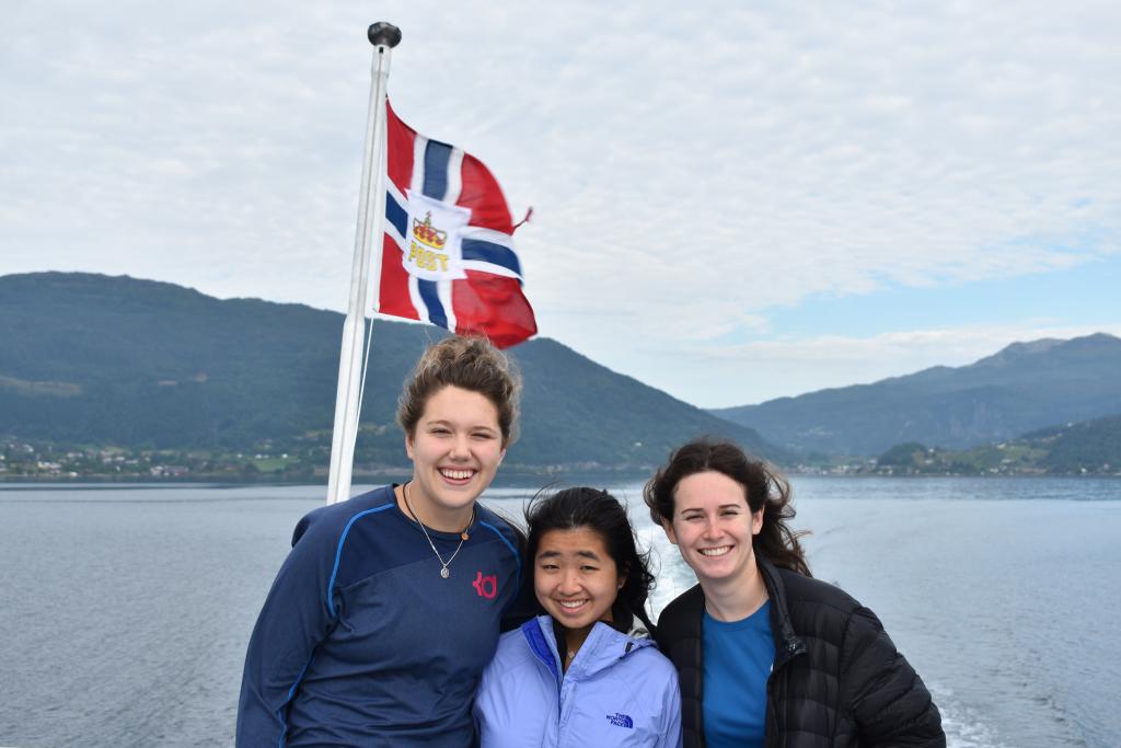 Teenage travelers sailing on a boat cruise in Norwegian fjords during summer youth travel program in Scandinavia