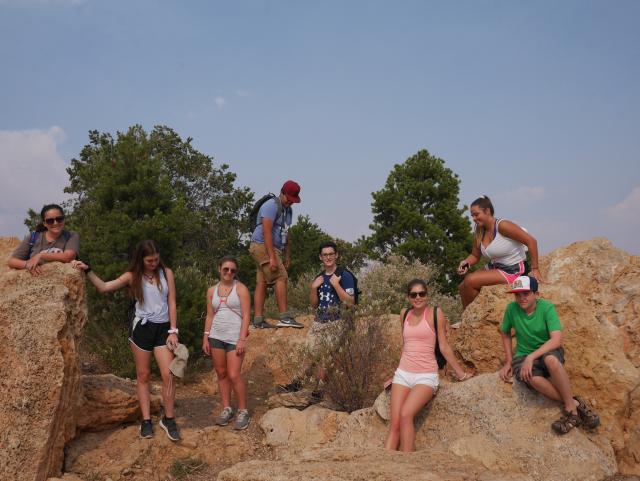 A group of teens takes a break from hiking on their summer tour of North America.