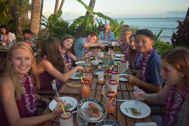 A group of teens enjoy a traditional luau in Hawaii on their summer travel program.