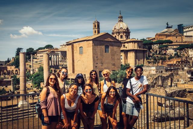 High school students smile in Rome during their summer tour of Italy