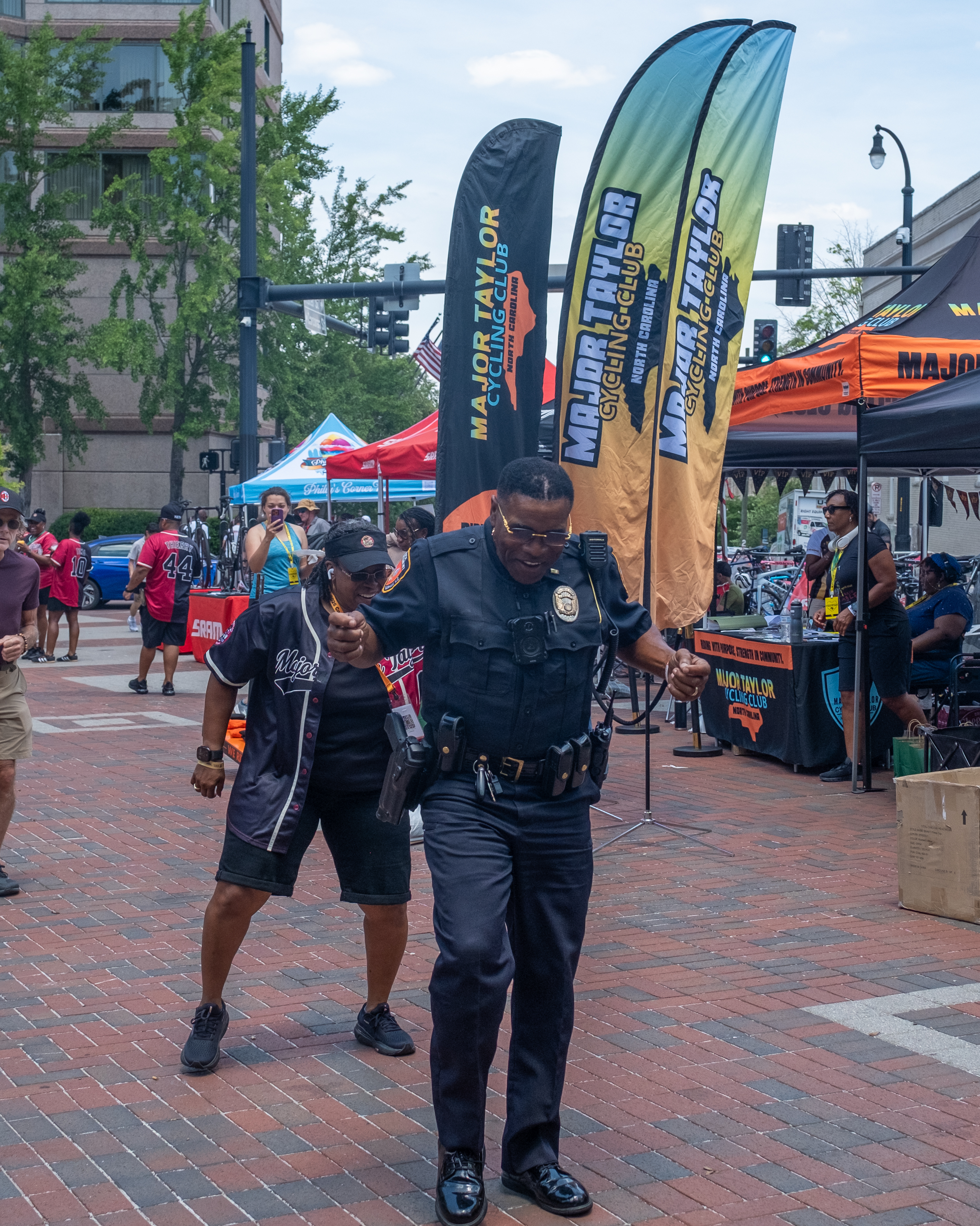 A Durham police officer and an attendee dancing at a downtown festival