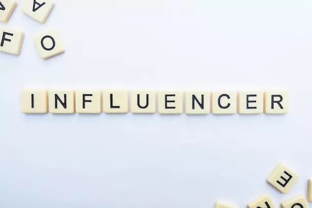 influencer spelled out using scrabble pieces