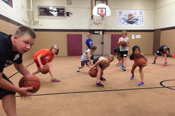 Rookie basketball team doing drills on an indoor court