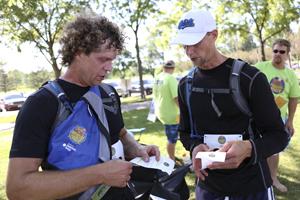 Racers from the Adventure Guys team read their clue