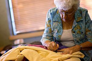 Delores Fitzgerald sewing one of the many quilts she has donated to The Salvation Army