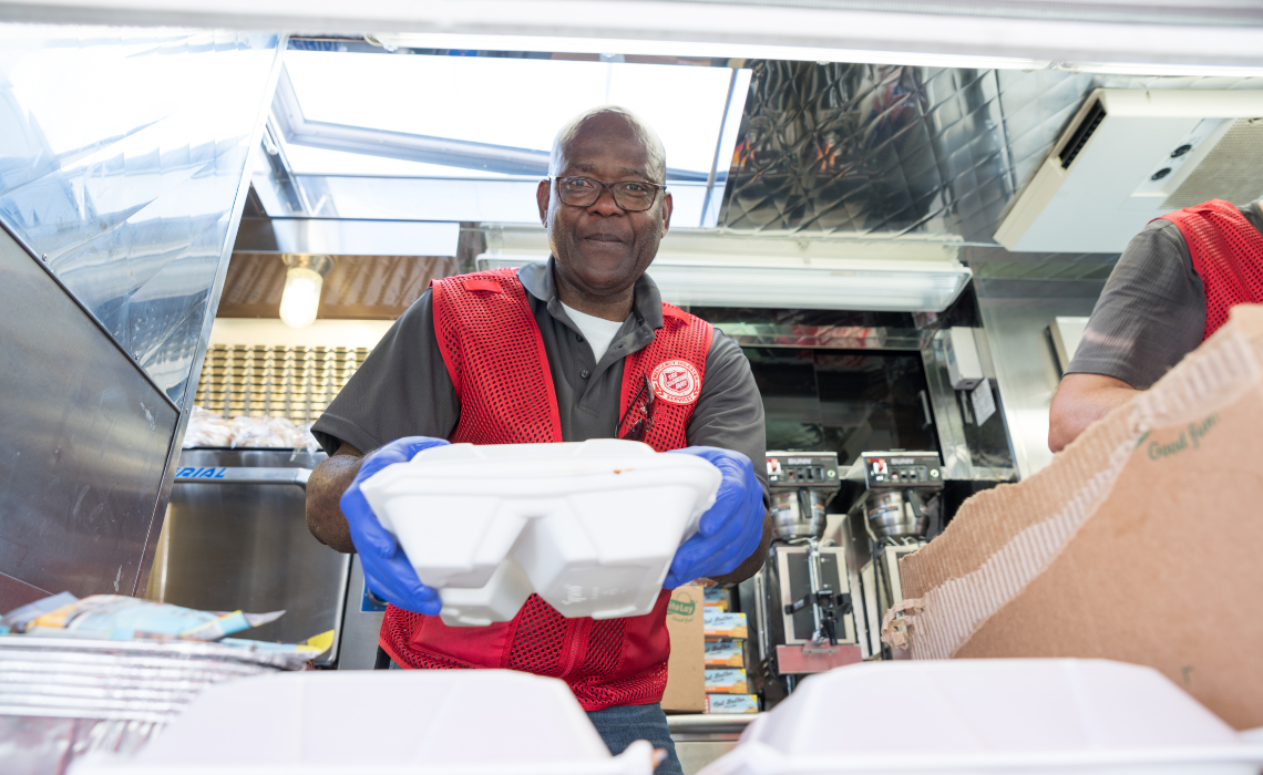 Salvation Army volunteer serving food