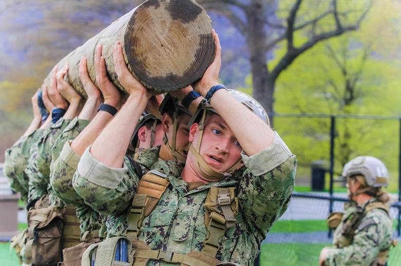 During Sandhurst, 44 teams representing four U.S. service academies, including 25 USMA teams, and 16 ROTC programs competed against one another in a variety of military-related events, including a log carry during the Crucible Challenge (above and left) and Zodiac course on Lusk Reservoir (right). 