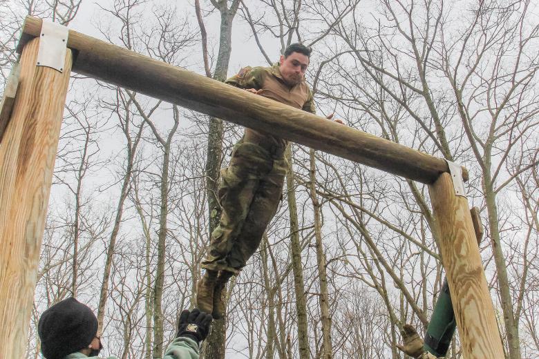 U.S. Military Academy Black Team leader Class of 2021 Cadet John Sweeney leaps to the higher log to get across the obstacle known as the ‘dirty name’ during the 52nd Sandhurst Military skills competition on April 17. Cadets mount the low log and jump onto the middle log. Cadets pull themselves onto the middle log and jump onto the high log. Then they grasp over the top of the log with both arms keeping their belly area in contact with it. They swing their legs over the log, then lower themselves to the 