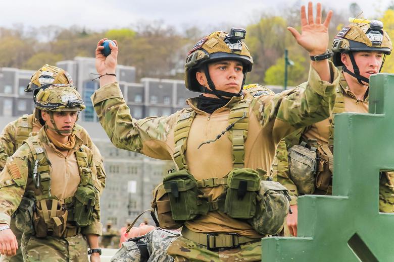 A member from the U.S. Air Force Academy team (above) throws a grenade while the group runs through the Crucible Challenge at the 52nd Sandhurst Military Skills Competition April 17. USAFA performed with great intensity as it ranked third in the Sandhurst relay leaving USMA Black in fourth place and the U.S. Naval academy team in fifth place at that juncture. USAFA finished eighth overall at Sandhurst.